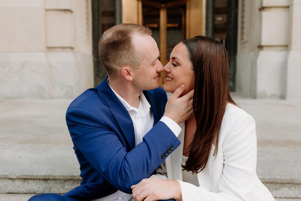 Newlyweds leaning in for a kiss after their courthouse wedding in Omaha.
