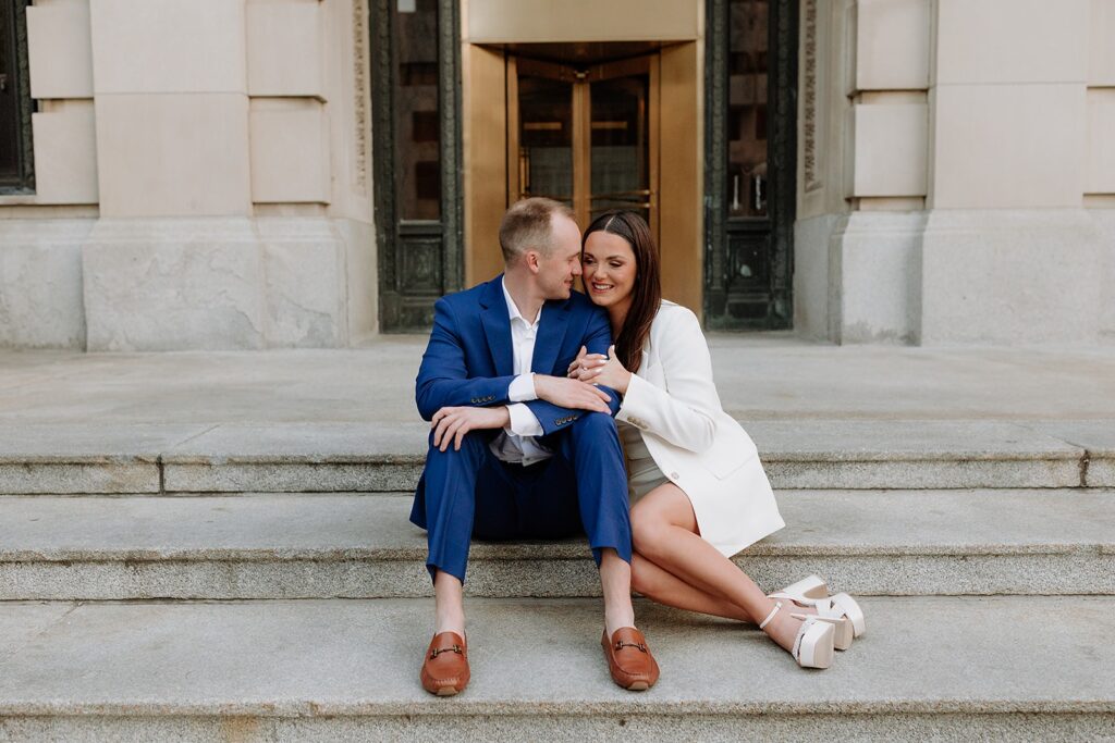Newlyweds sitting outside the Douglas County Courthouse after their Omaha courthouse wedding.