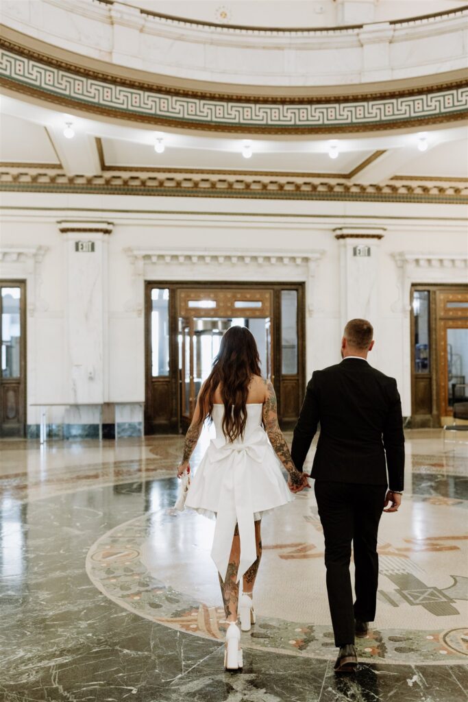 bride and groom exiting the courthouse after their small ceremony 