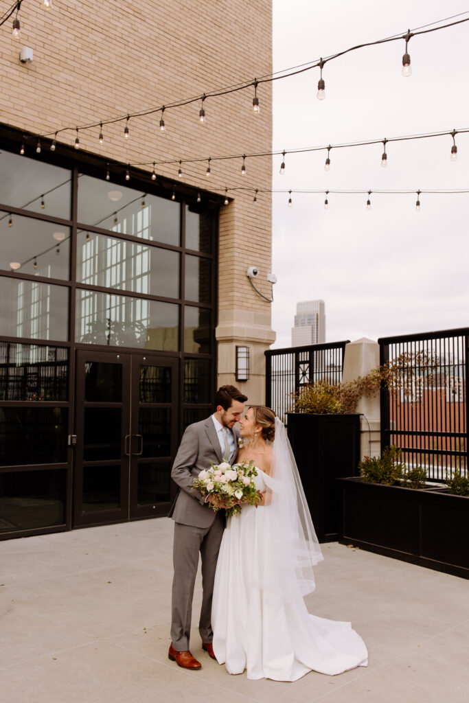 outdoor portraits on the patio area of their intimate wedding venue 