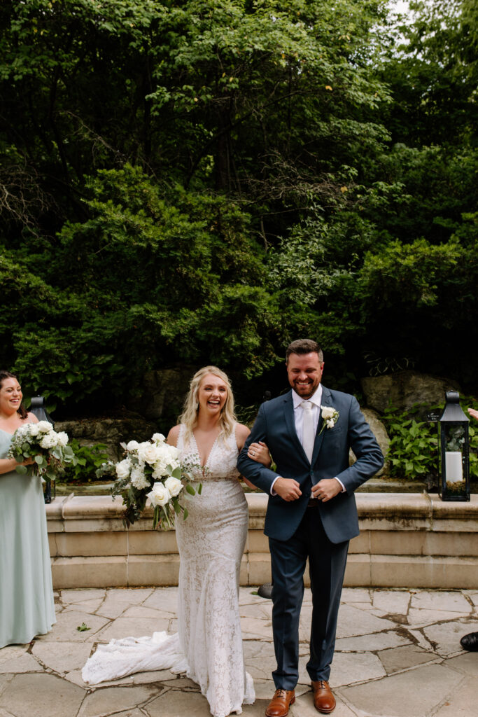 Bride and groom walk down the aisle after their intimate ceremony at the Elmwood Park Grotto in Omaha
