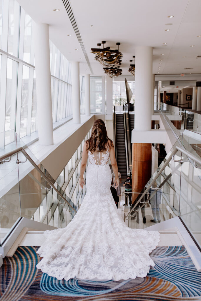 Bride walking downstairs for a hotel wedding