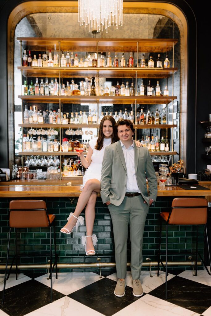 Bride and groom pose at the bar at Hotel Deco