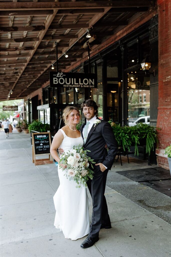 Bride and groom outside Le Bouillon in Omaha