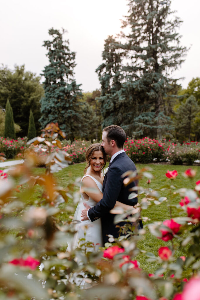 Newlyweds pose among roses at Memorial park in Omaha