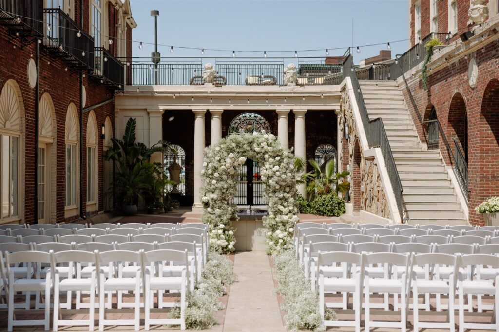 Floral arch and aisle at Hotel Magnolia wedding ceremony