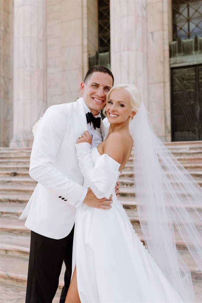 Bride and groom smile at The Joslyn Art Museum wedding venue.