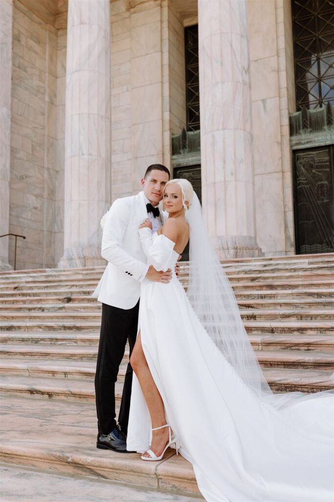 Bride and groom smile at The Joslyn Art Museum wedding in Omaha.