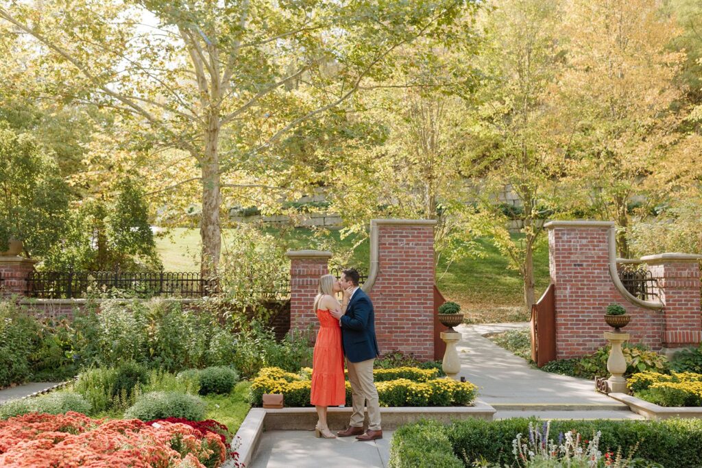 Couple kiss at Lauritzen Gardens in Omaha NE.