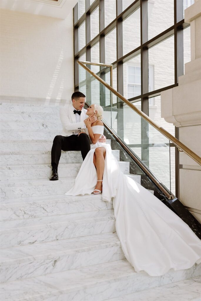 Bride and groom on stairs at Leo Ballroom in Omaha.